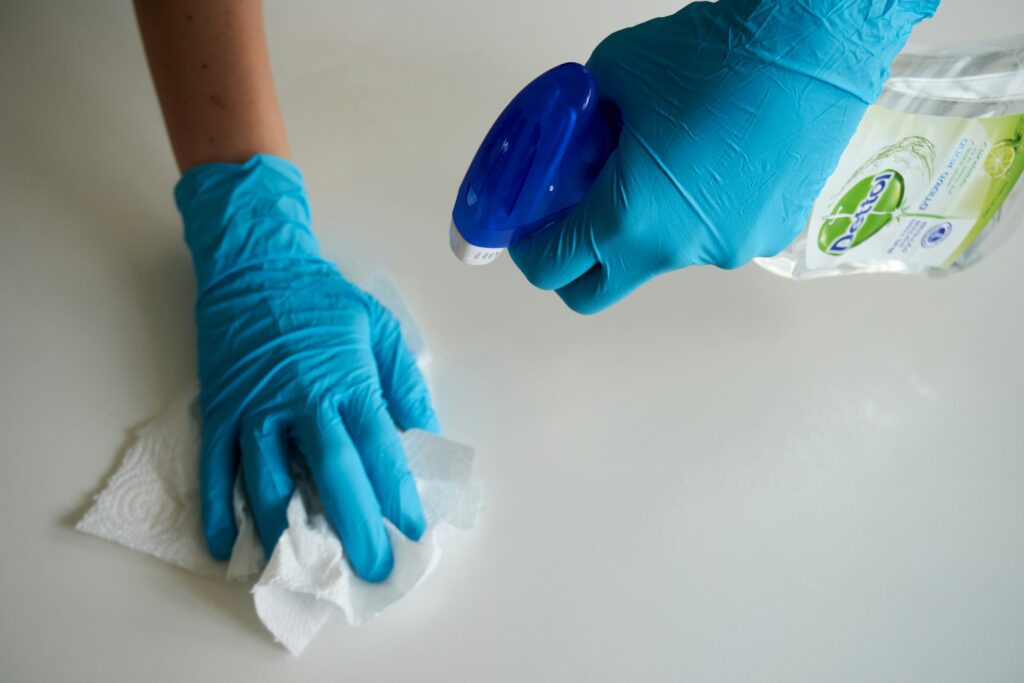 If Heated Water Is Used to Sanitize It Must Be at 171°F or Higher: Food handler checking hot water temperature while sanitizing dishes, utensils, and food-contact surfaces.
