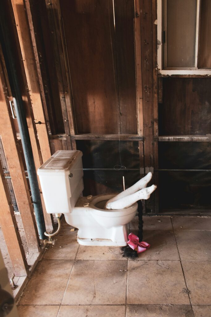 How to Unclog Toilet Without Plunger: Homeowner using a safe DIY method to clear a clogged toilet with common household items while avoiding damage to the plumbing system.